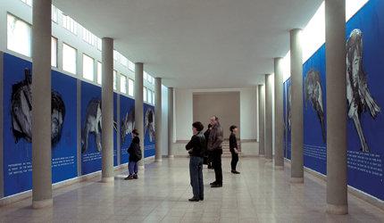   Visitors looking at artworks on the museum walls